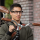 Man carrying bike while wearing Amazon's Echo Frames smart glasses.